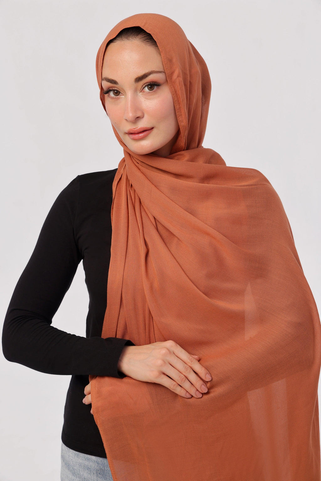 Burnt Orange Modal Hijab - worn by model, lightweight and flowy drape.