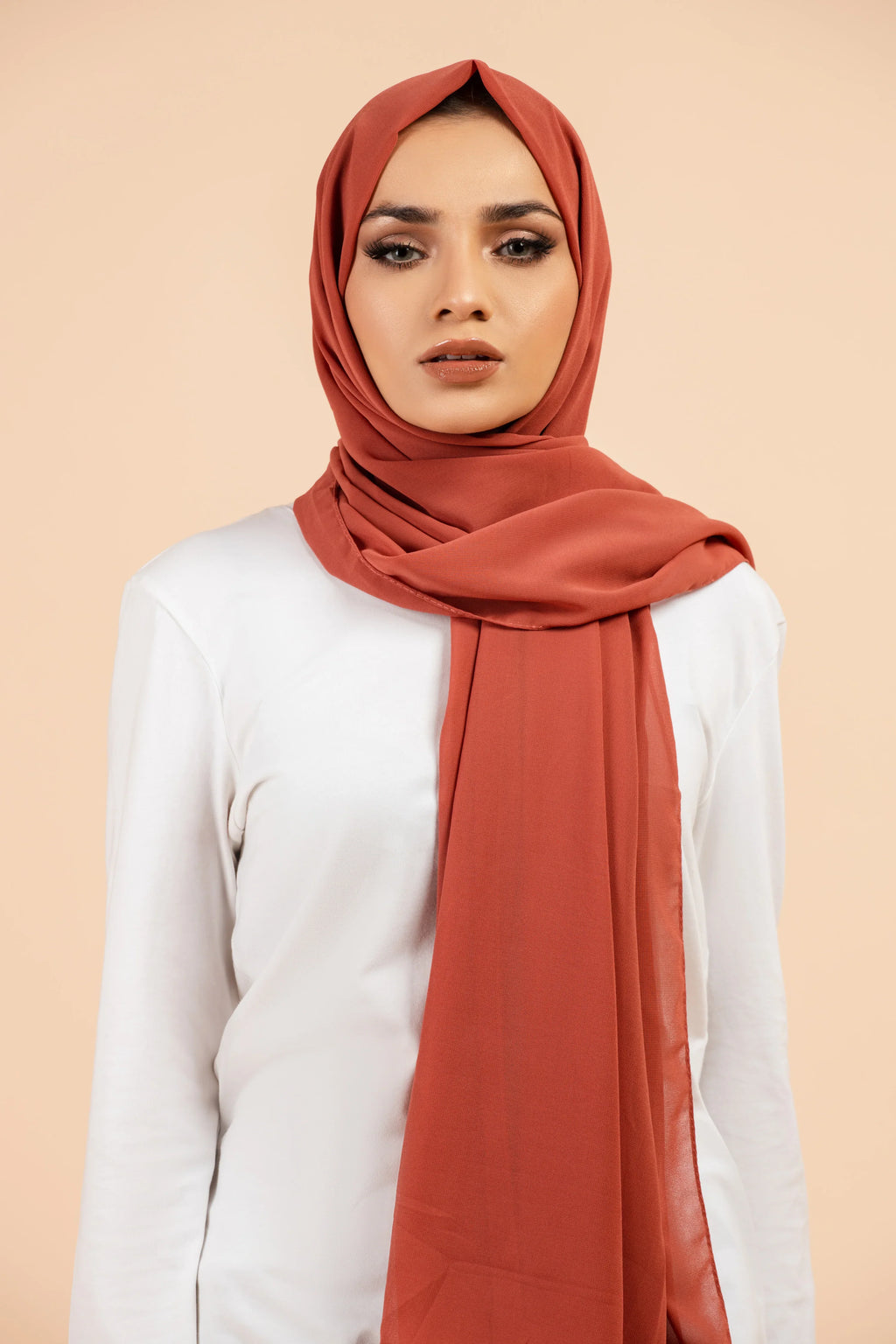 Premium Georgette - Burnt Orange Georgette Hijab worn by model, lightweight and flowy drape.