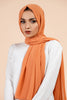 Premium Georgette - Coral Bliss Georgette Hijab worn by model, lightweight and flowy drape.