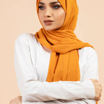 Premium Georgette - Mustard Georgette Hijab worn by model, lightweight and flowy drape.